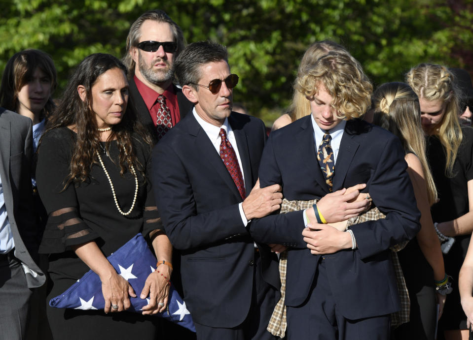 Parents of Riley Howell, Natalie Henry-Howell, center left, stands next to Thomas Howell, comforting their son Teddy, after a memorial service for Riley Howell in Lake Junaluska, N.C., Sunday, May 5, 2019. Family and hundreds of friends and neighbors are remembering Howell, a North Carolina college student credited with saving classmates' lives by rushing a gunman firing inside their lecture hall. (AP Photo/Kathy Kmonicek)