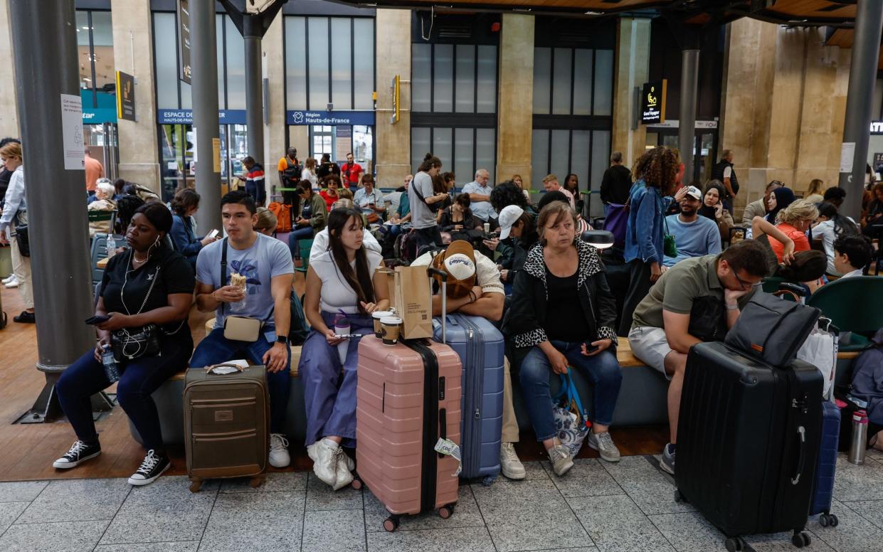 Stranded passengers wait inside Gare du Nord station in Paris following cancellations