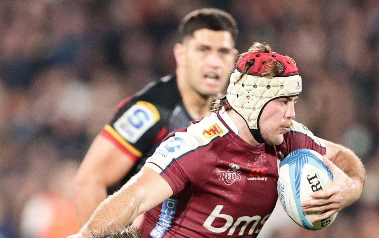 Reds' Fraser McReight is tackled by Chiefs' Cortez Ratima during the Super Rugby Pacific quarterfinal match between Waikato Chiefs and Queensland Reds