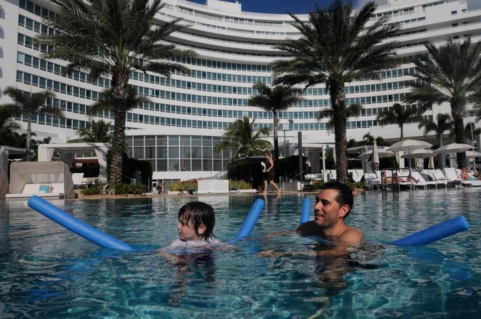 Todd Rosenberg, right, and his 3 1/2 year old son Rylan, of Boca, vacation at the Fontainebleau Hotel in Miami Beach in December 2009. Rosenberg said he loved it because he had the pool to himself. Last night he and his wife ate in the hotel restaurant and were the only ones there.