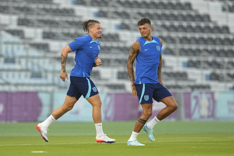 England Midfielder Kalvin Phillips, left, and defender Ben White take the field during England's official training on the eve of the group B World Cup soccer match between England and Iran, at Al Wakrah Sports Complex, in Al Wakrah, Qatar, Sunday, Nov. 20, 2022. (AP Photo/Abbie Parr)