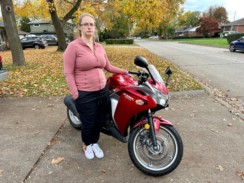 Jaime Poisson, mother of Dakota Rivard of Windsor, with one of her late son's motorcycles, a Honda CBR.