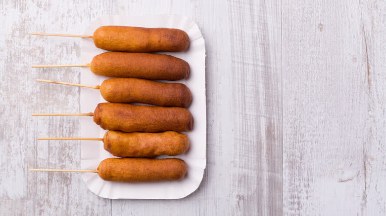 Baked corn dogs on paper plate