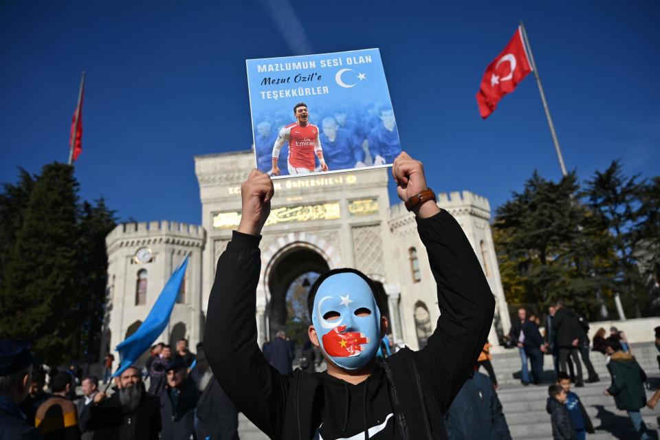 A supporter of China's Muslim Uighur minority holds a placard of Ozil during a demonstration in Istanbul in December 2019 (AFP via Getty Images)