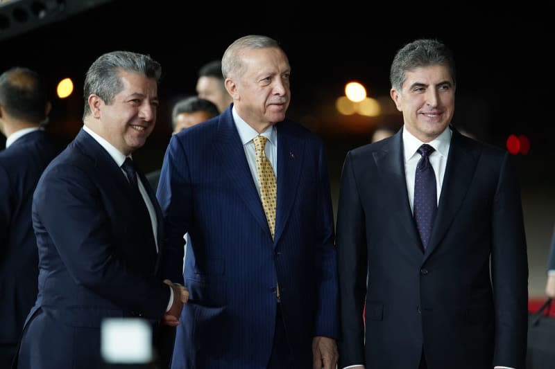 President of the Kurdistan region in Iraq Nechirvan Barzani (R) and Iraqi Kurdish Prime Minister Masrour Barzani (L) receive Turkish President Recep Tayyip Erdogan (C) during a welcoming ceremony at Erbil International Airport (EIA). Ismael Adnan/dpa