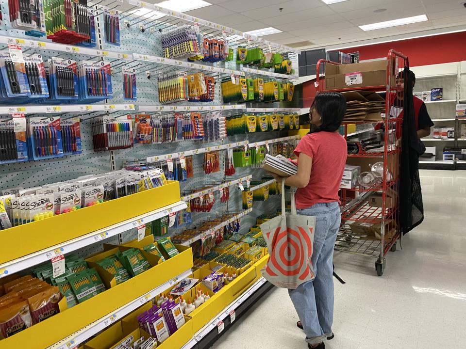 Customer shopping for school supplies with employee restocking shelves, Target store, Queens, New York. (Photo by: Lindsey Nicholson/UCG/Universal Images Group via Getty Images)