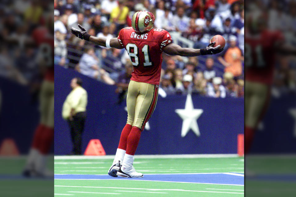 In a now infamous moment, Terrell Owens celebrates scoring a touchdown for the San Francisco 49ers on top of the Dallas Cowboys star in 2000. (AP)