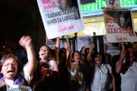 Activists celebrate after hearing the news that the excution of Filipina Mary Jane Veloso was postponed, during a vigil in front of the Indonesian embassy in Manila on April 29, 2015