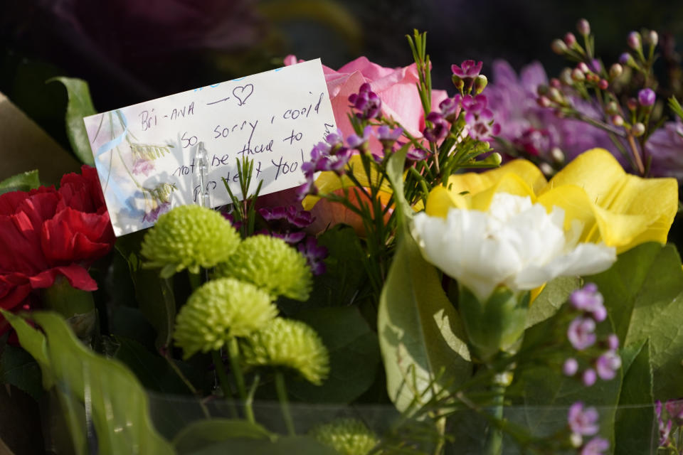 A note is among flowers and candles that were placed outside Croft House store in honor of Brianna Kupfer on Tuesday, Jan. 18, 2022, in Los Angeles. The Los Angeles Police Department, West Bureau Homicide detectives are investigating the murder of Kupfer, a 24-year-old Pacific Palisades resident, who was killed at a business in the 300 block of North La Brea Avenue on Jan. 13. (AP Photo/Ashley Landis)