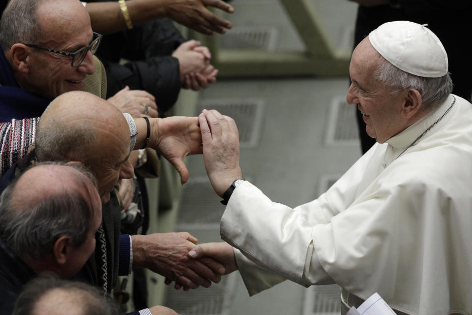 Pope Francis is greeted by faithful during the weekly general audience at the Vatican, Wednesday, Feb. 12, 2020. (AP Photo/Gregorio Borgia)