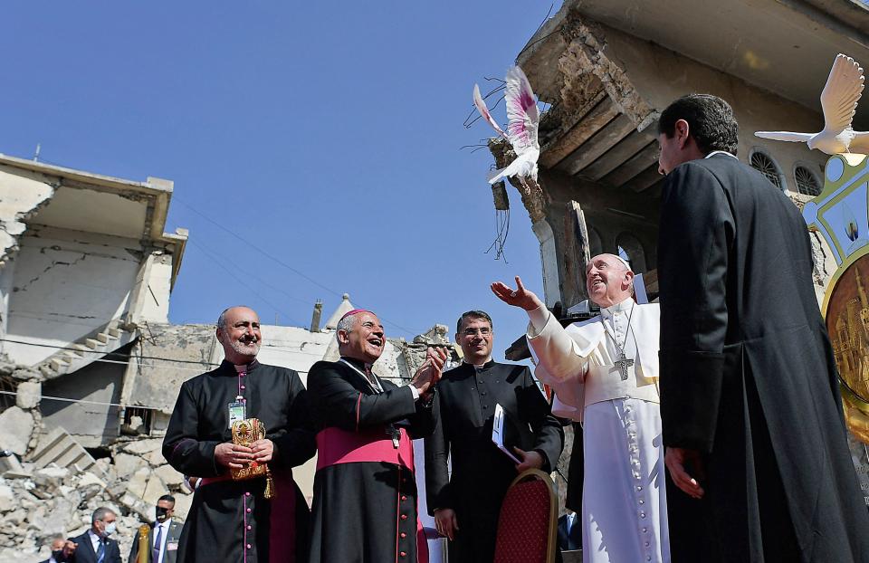 <p>Pope Francis, accompanied by the Chaldean Catholic Archbishop of Mosul Najib Michaeel Moussa (left), looks on at a square near the ruins of the Syriac Catholic Church of the Immaculate Conception (al-Tahira-l-Kubra), in Mosul on 7 March, 2021</p> (AFP/Getty)