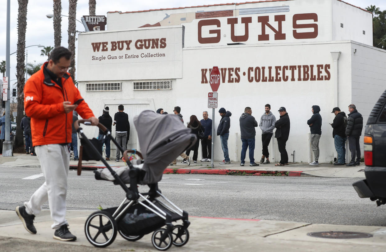 People stand in line outside the Martin B. Retting, Inc. guns store in Culver City, California, on Sunday. (Photo: Mario Tama via Getty Images)