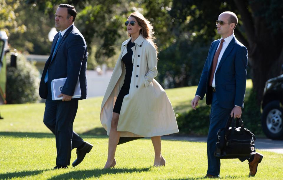 (FILES) In this file photo taken on September 21, 2020 Dan Scavino (L), Director of White House Social Media, Hope Hicks, White House counselor, and Stephen Miller (R), White House senior advisor, walk to Marine One prior to departing with US President Donald Trump.