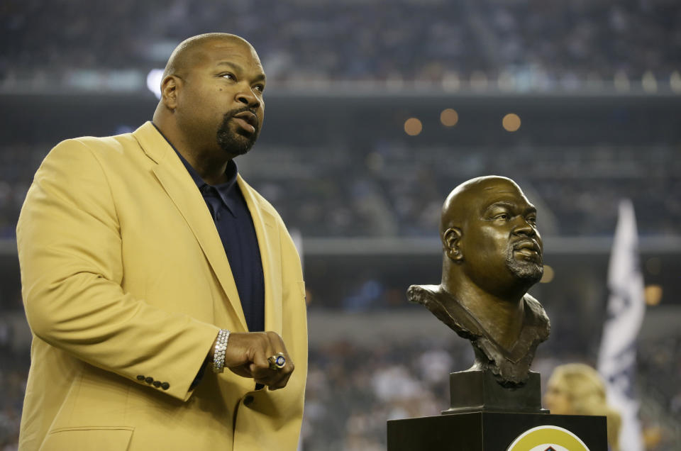 FILE - Dallas Cowboys Hall of Fame Inductee Larry Allen shows off his Hall of Fame ring at halftime of an NFL football game, Oct. 13, 2013, in Arlington, Texas. Allen, one of the most dominant offensive linemen in the NFL during a 12-year career spent mostly with the Dallas Cowboys, died suddenly on Sunday, June 2, 2024, while on vacation with his family in Mexico, the Cowboys said. He was 52. (AP Photo/Tim Sharp, File)