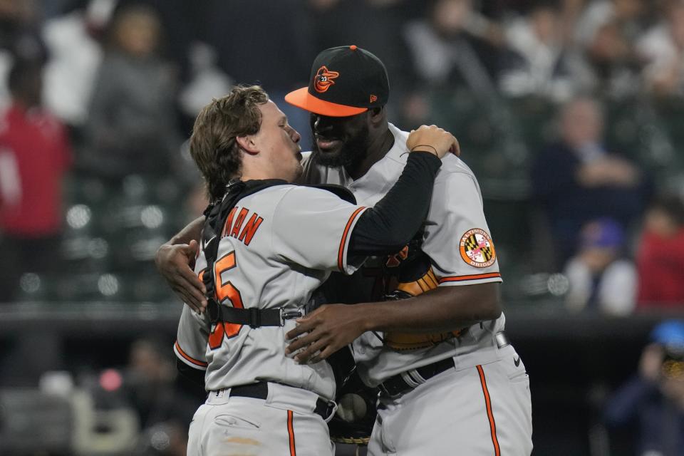 Baltimore Orioles catcher Adley Rutschman, left, and relief pitcher Felix Bautista hug after winning a baseball game against the Chicago White Sox, Friday, April 14, 2023, in Chicago. (AP Photo/Erin Hooley)
