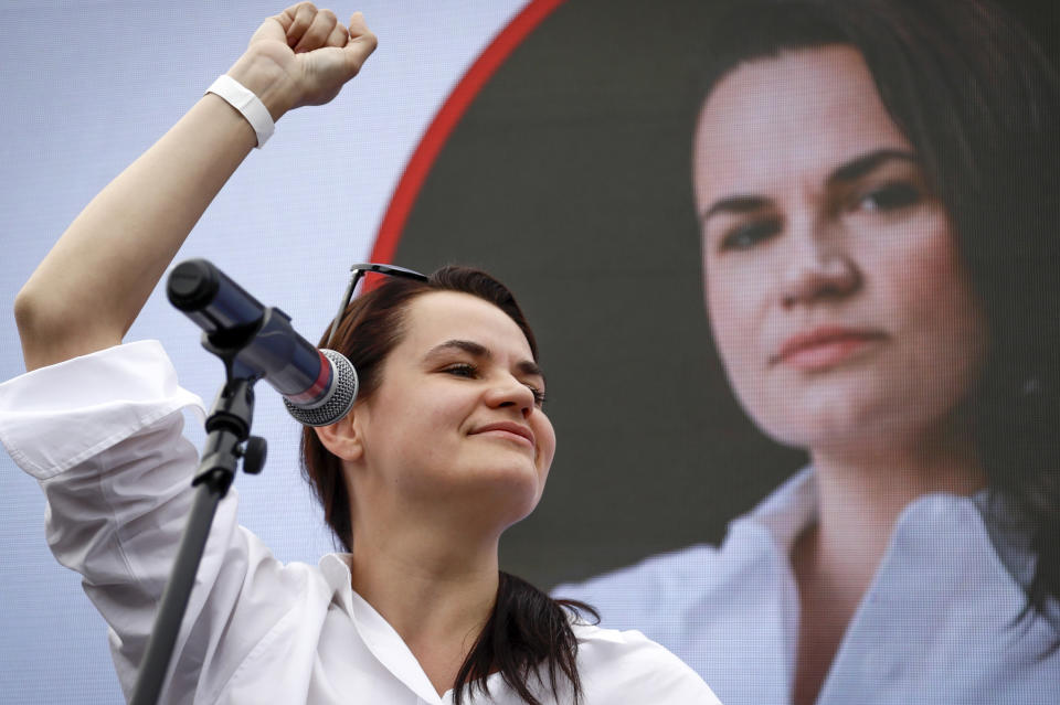 FILE - In this Sunday, July 19, 2020, file photo, Sviatlana Tsikhanouskaya, candidate for the presidential elections, reacts during a meeting with her supporters in Minsk, Belarus. 37-year old Tsikhanouskaya, without any political experience has united various opposition forces and drawn tens of thousands to her campaign rallies the biggest demonstrations the ex-Soviet country has ever seen since becoming independent in 1991. (AP Photo/Sergei Grits, File)