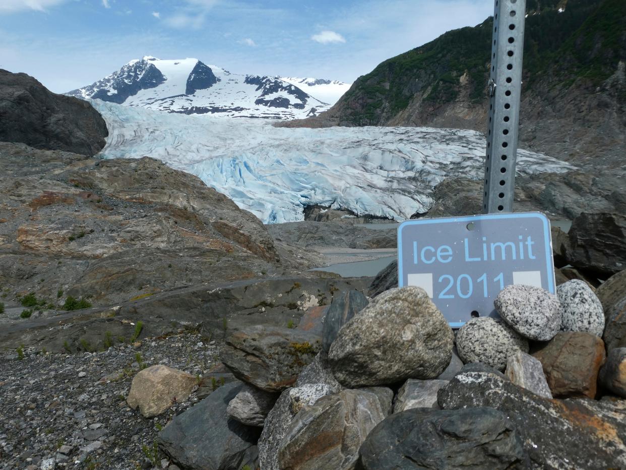 The "Ice Limit 2011" sign shows the Mendenhall Glacier's retreat on June 8, 2023, in Juneau, Alaska. As the Mendenhall Glacier continues to recede, tourists are flooding into Juneau. A record number of cruise ship passengers are expected this year in the city of about 30,000 people.