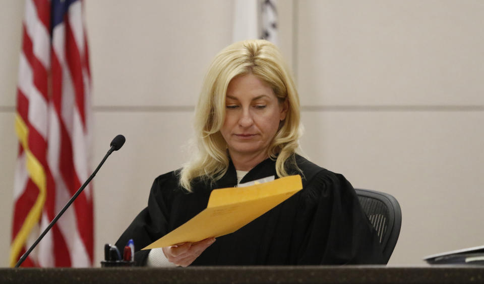 Monterey County Superior Court Judge Jennifer J. O'Keefe reads a verdict envelope during Ruben Flores' trial in Monterey County Superior Court on Tuesday, Oct. 18, 2022, in Salinas, Calif. The jury acquitted Ruben Flores of helping his son, Paul Flores, cover up the murder of Cal Poly student Kristin Smart. (Laura Dickinson/The Tribune via AP, Pool)