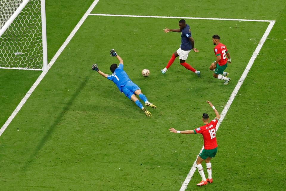 France’s forward #12 Randal Kolo Muani (top) scores his team’s second goal past Morocco’s goalkeeper #01 Yassine Bounou during the Qatar 2022 World Cup semi-final (AFP via Getty Images)