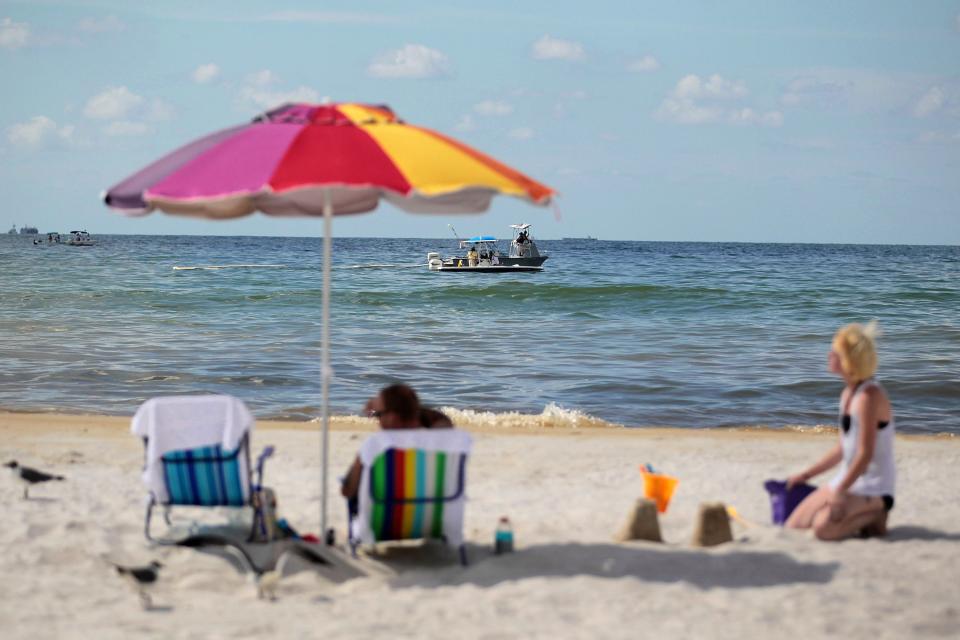 Beach goers relax in Orange Beach, Alabama on June 27, 2010.