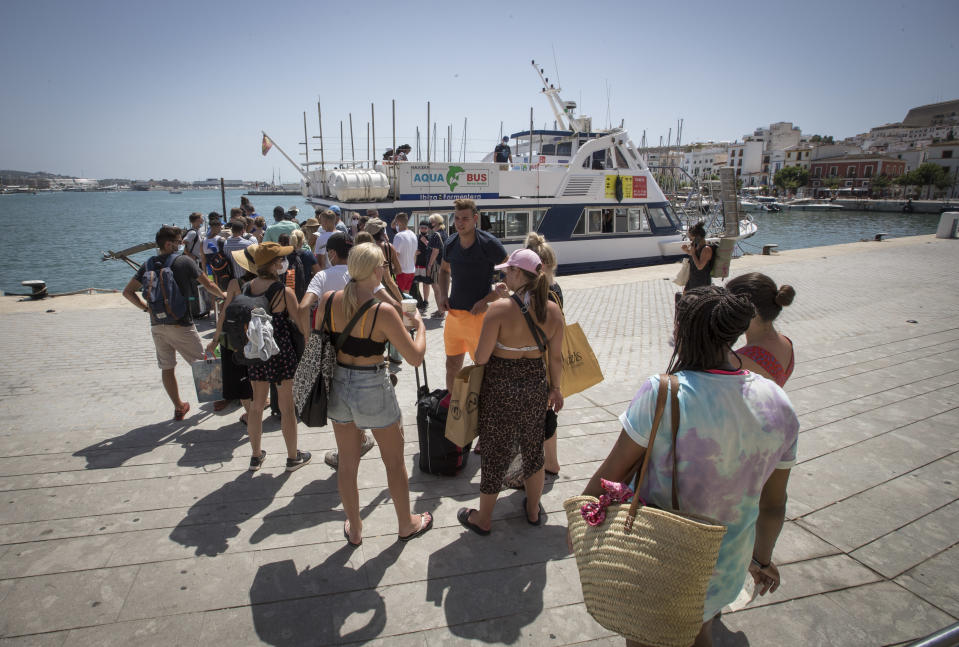 Tourist queue to board a ferry at Ibiza´s harbour, on July 31, 2020. - Spain plunged into recession in the second quarter after its gross domestic product tumbled by 18.5 percent due to the coronavirus pandemic, official figures showed. The business, transport and hotels sector were all badly hit, with a 40 percent drop compared with the first quarter. And tourism, a pillar of the Spanish economy which accounts for 12 percent of GDP, suffered with a 60 percent drop in revenues compared the same period in 2019. (Photo by JAIME REINA / AFP) (Photo by JAIME REINA/AFP via Getty Images)