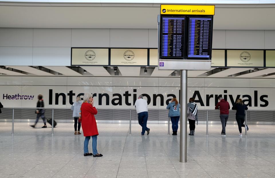 People wait for arriving passengers at Heathrow Airport's Terminal 5 in London on March 17, 2020.