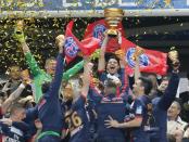 Paris Saint Germain's Thiago Motta, center, of Italy, and teammates celebrate with the cup after winning their French League Cup final soccer match against Lyon at the Stade de France in Saint Denis, north of Paris, Saturday April 19, 2014. (AP Photo/Jacques Brinon)