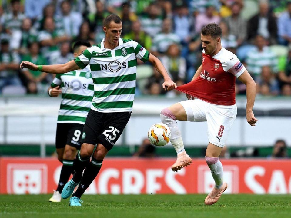 Aaron Ramsey controls the ball while under pressure from Radosav Petrovic (Getty)