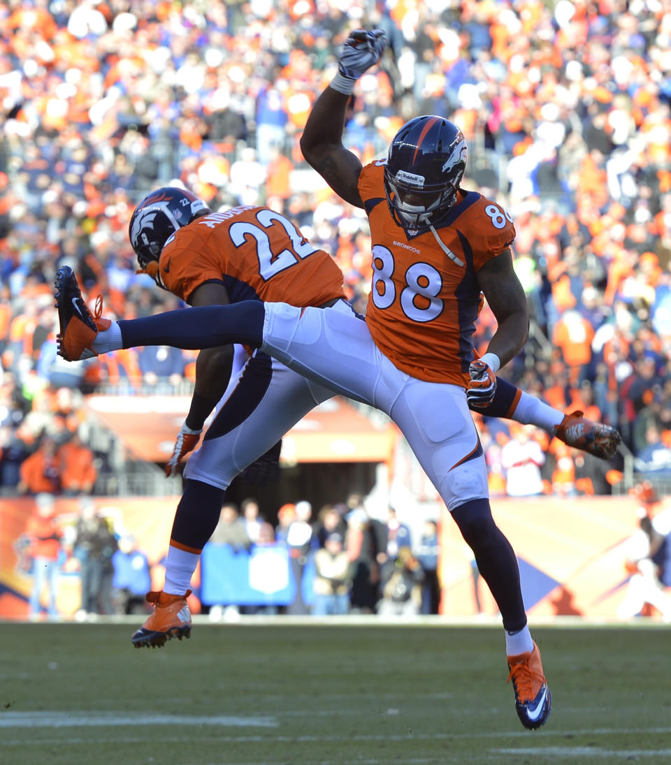 Denver Broncos wide receiver Demaryius Thomas (88) celebrates with Denver Broncos running back C.J. Anderson after scoring on a two-yard touchdown pass against the San Diego Chargers in the first quarter of an NFL AFC division playoff football game, Sunday, Jan. 12, 2014, in Denver. (AP Photo/Jack Dempsey)