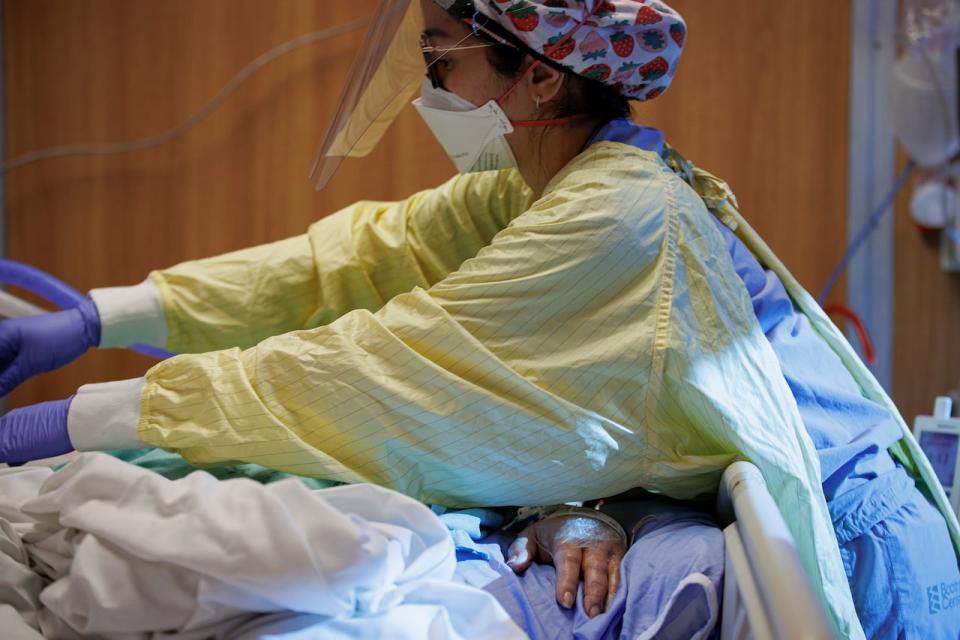 Nurse Ashley De Lumen attends to a COVID-19 patient on a ventilator in the intensive care unit of Humber River Hospital, in Toronto, on Jan. 25, 2022.