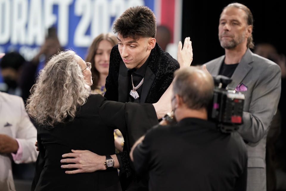 Chet Holmgren, center, hugs family and friends after being selected second overall in the NBA basketball draft by the Oklahoma Thunder, Thursday, June 23, 2022, in New York. (AP Photo/John Minchillo)