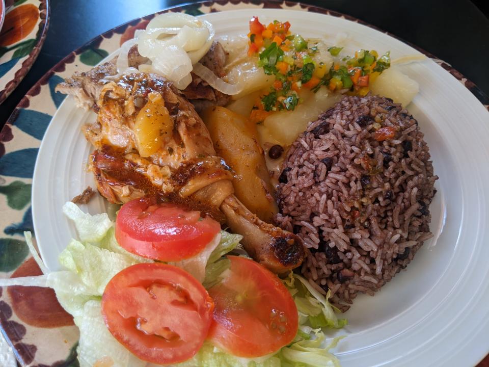 A plate of fricase de pollo, bistec de res con cebolla, yuca, plátano, arroz congri and ensalada served May 7, 2022 at Cocina La Negra.