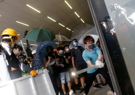 Protesters break into the Legislative Council building during the anniversary of Hong Kong's handover to China in Hong Kong