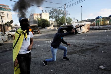 A Palestinian protester fires a homemade weapon at Israeli security forces during clashes in east Jerusalem October 30, 2014. REUTERS/Ammar Awad