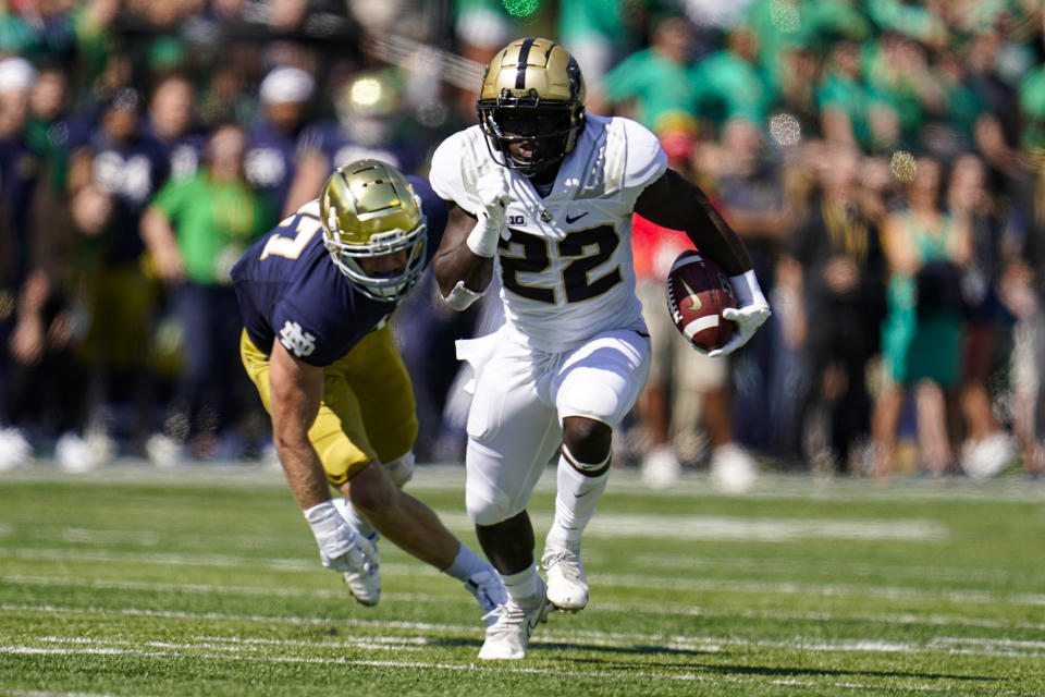 Purdue running back King Doerue (22) runs past Notre Dame linebacker JD Bertrand (27) during the first half of an NCAA college football game in South Bend, Ind., Saturday, Sept. 18, 2021. (AP Photo/Michael Conroy)