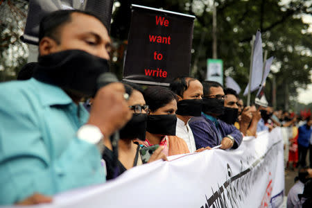 FILE PHOTO: Journalists hold banners and placards as they protest against the newly passed Digital Security Act in front of the Press Club in Dhaka, Bangladesh, October 11, 2018. REUTERS/Mohammad Ponir Hossain/File Photo