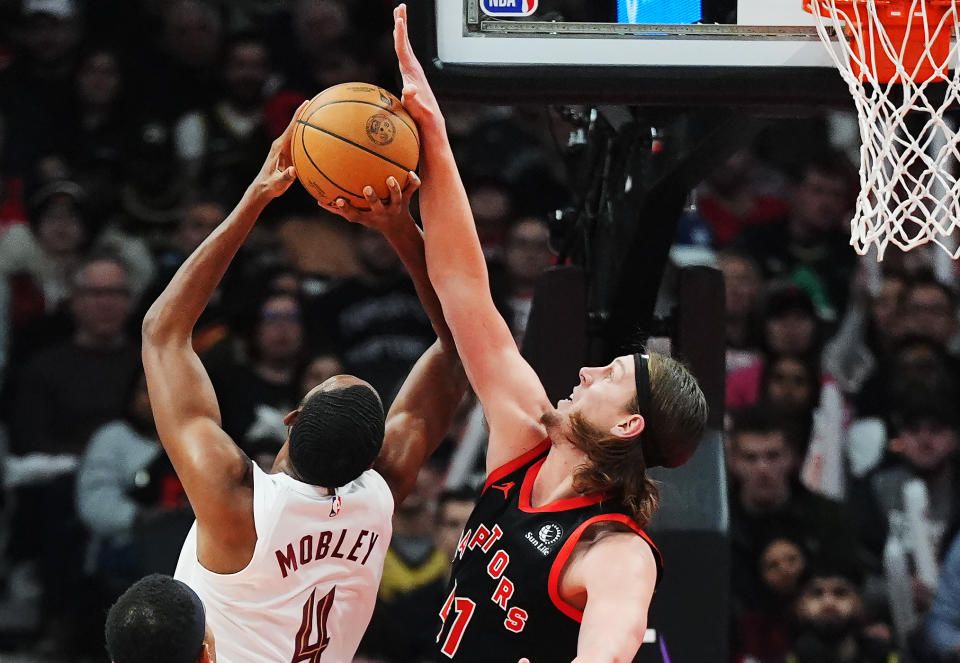 Cleveland Cavaliers forward Evan Mobley (4) is blocked by Toronto Raptors forward Kelly Olynyk (41) during the first half of an NBA basketball game, Saturday, Feb. 10, 2024 in Toronto. (Frank Gunn/The Canadian Press via AP)