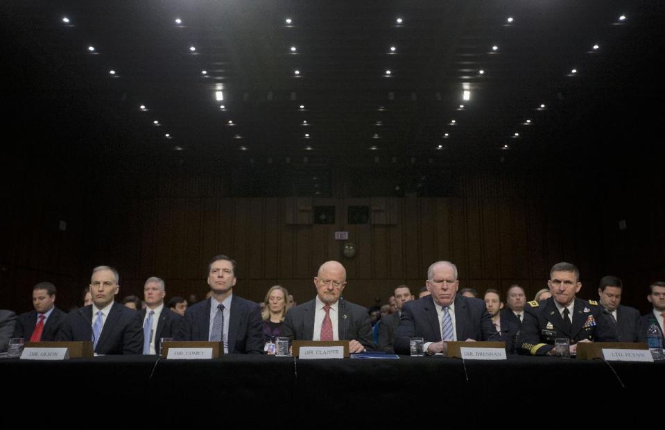 Director of National Intelligence James Clapper, center, and other security agency officials, testify on Capitol Hill in Washington, Wednesday, Jan. 29, 2014, before the Senate Intelligence Committe hearing on current and projected national security threats against the US. From left are, National Counterterrorism Center Director Matthew Olsen, FBI Director James Comey, CIA Director John Brennan, and Defense Intelligence Agency Director Lt. Gen. Michael Flynn. (AP Photo/Pablo Martinez Monsivais)