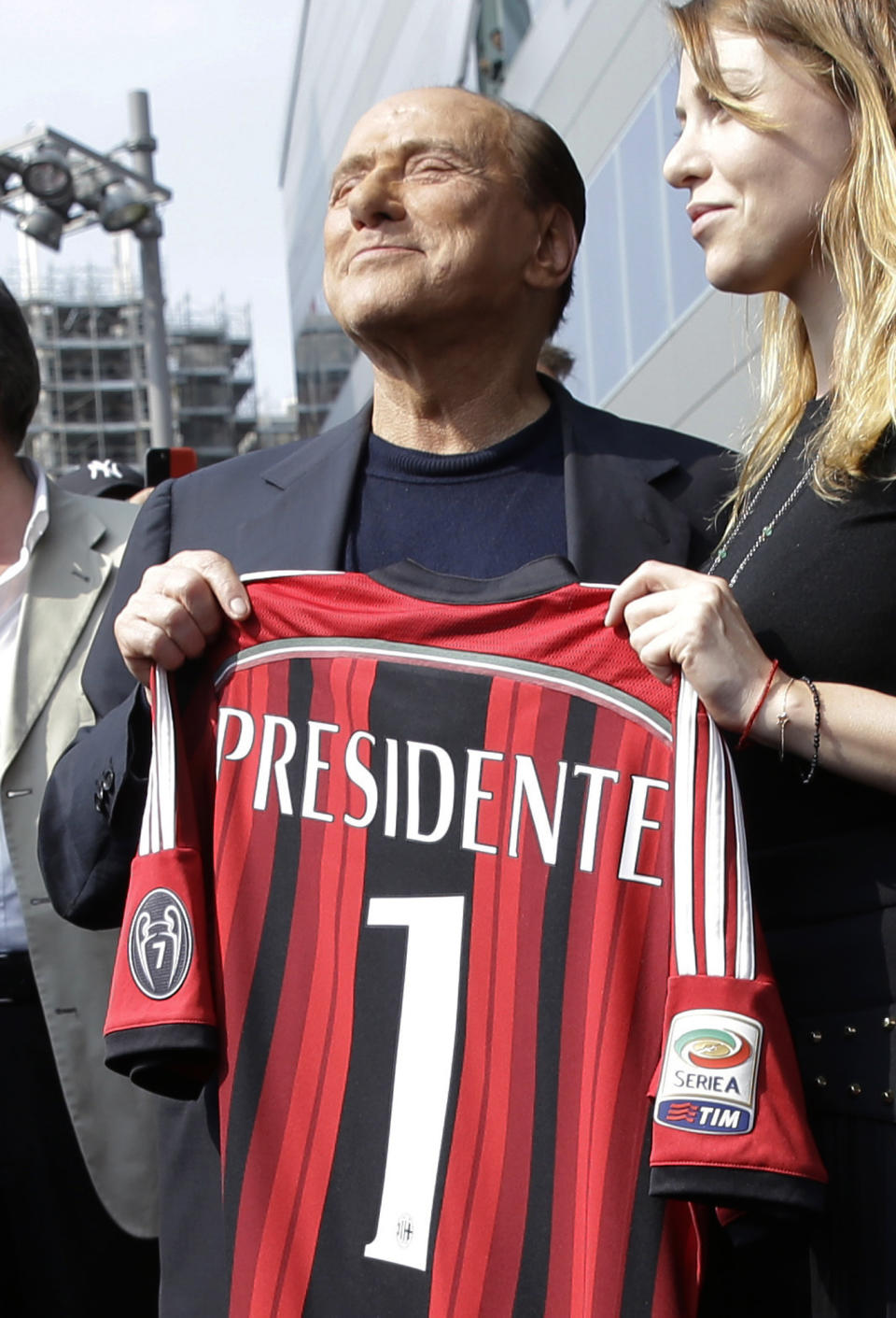 FILE - In this June 6, 2014 file photo, AC Milan president Silvio Berlusconi, left, holds an AC Milan shirt flanked by his daughter Barbara during a visit to the new team headquarters in Milan, Italy. Berlusconi, the boastful billionaire media mogul who was Italy's longest-serving premier despite scandals over his sex-fueled parties and allegations of corruption, died, according to Italian media. He was 86. (AP Photo/Luca Bruno)