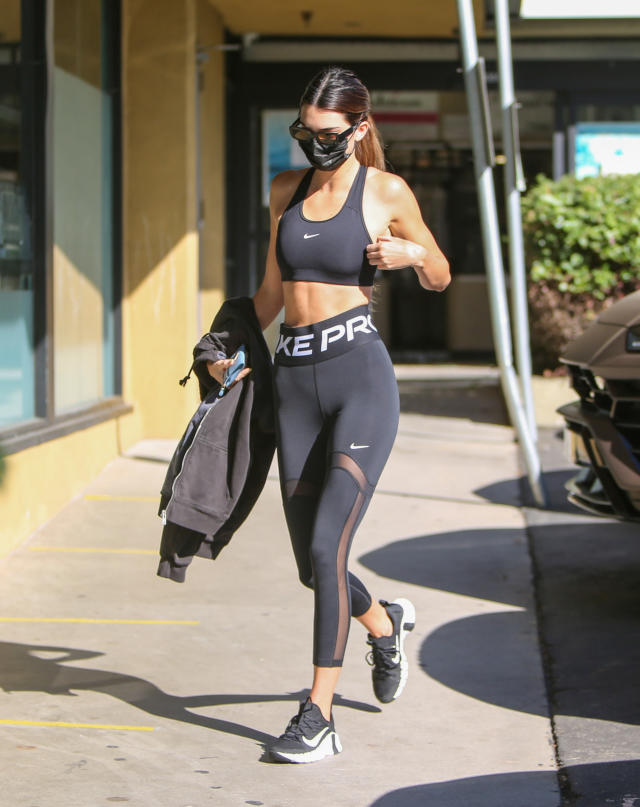 Kendall Jenner sports a black sweatshirt with matching leggings