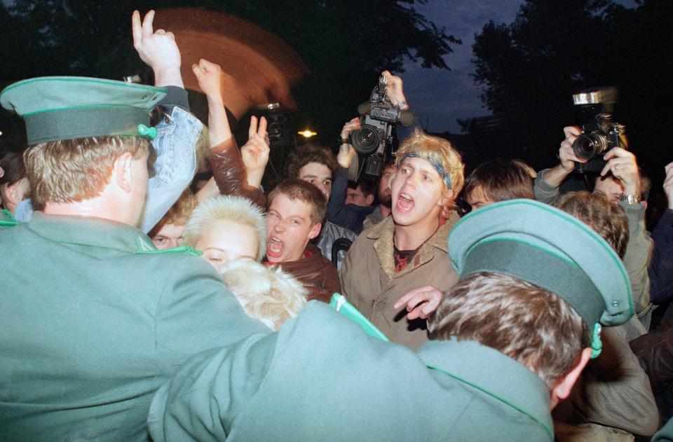 East German policemen, foreground, try to stop demonstrators from moving toward the East German parliament building, Oct. 7, 1989, where Soviet President Mikhail S. Gorbachev attended a reception. Several thousand young people demanded democratic reforms in East Germany.