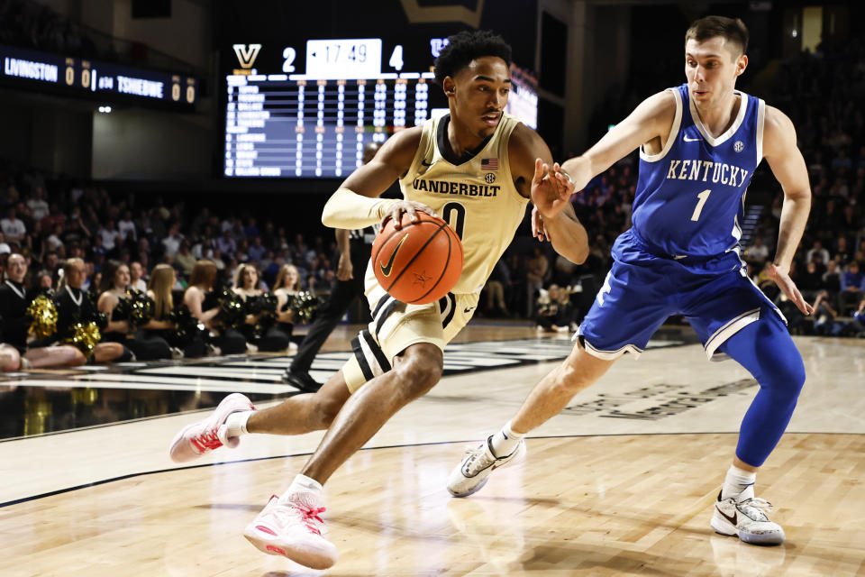 Vanderbilt guard Tyrin Lawrence (0) drives against Kentucky guard CJ Fredrick (1) during the first half of an NCAA college basketball game Tuesday, Jan. 24, 2023, in Nashville, Tenn. (AP Photo/Wade Payne)