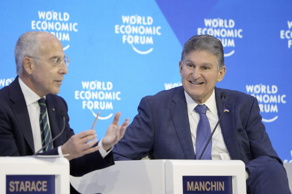 US Senator Joe Manchin and CEO of Enel Francesco Starace, from right, speak on the podium at the World Economic Forum in Davos, Switzerland Thursday, Jan. 19, 2023. The annual meeting of the World Economic Forum is taking place in Davos from Jan. 16 until Jan. 20, 2023. (AP Photo/Markus Schreiber)