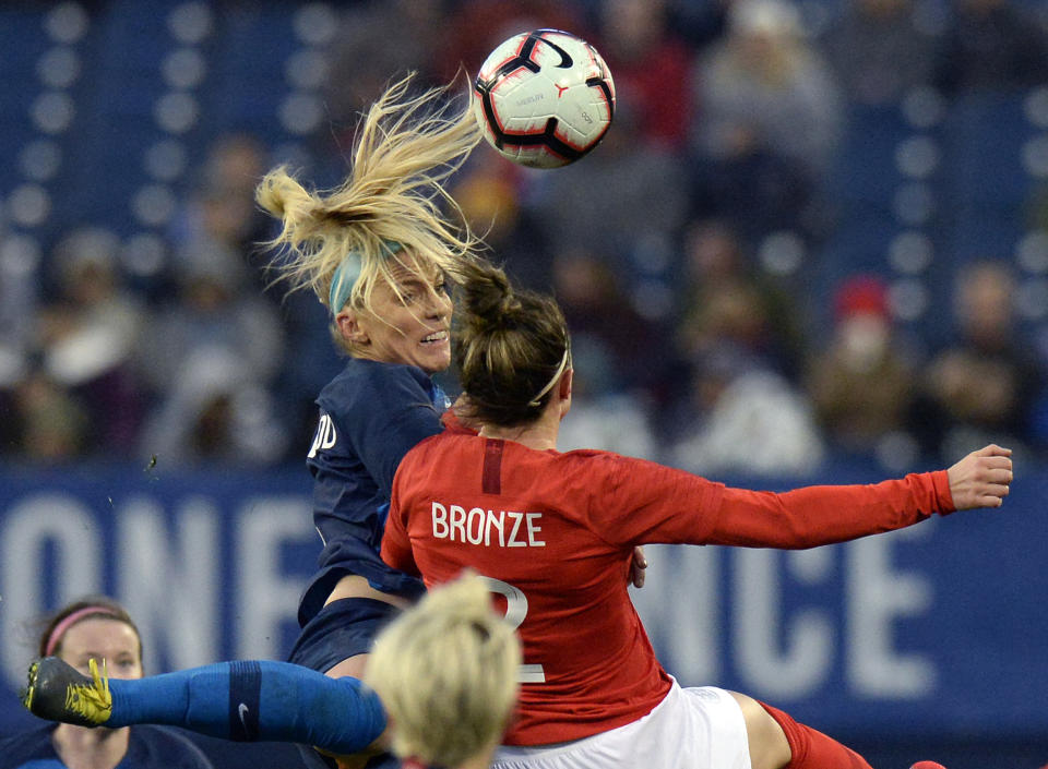 United States midfielder Julie Ertz, top left, heads the ball as she is defended by England defender Lucy Bronze (2) during the second half of a SheBelieves Cup women's soccer match Saturday, March 2, 2019, in Nashville, Tenn. (AP Photo/Mark Zaleski)