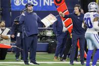 Dallas Cowboys head coach Mike McCarthy and offensive coordinator Kellen Moore, right, question officials after a pass interference call in overtime of an NFL football game against the Las Vegas Raiders in Arlington, Texas, Thursday, Nov. 25, 2021. (AP Photo/Michael Ainsworth)