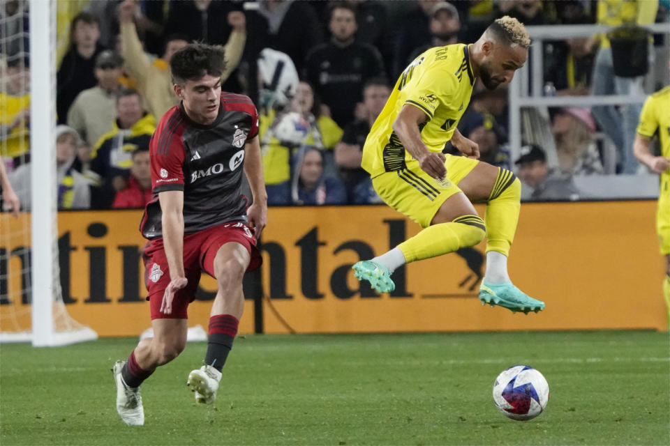 Toronto FC's Alonso Coello, left, and Nashville SC's Hany Mukhtar (10) chase the ball during the second half of an MLS soccer match Saturday, April 8, 2023, in Nashville, Tenn. (AP Photo/Mark Humphrey)