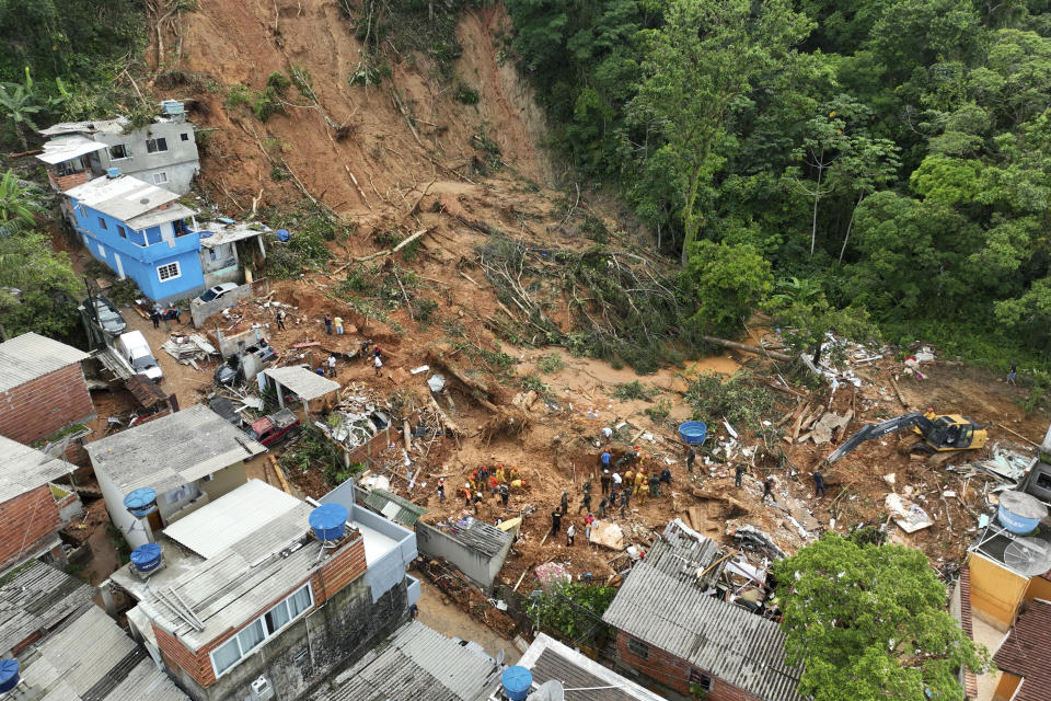 Rescue workers look for bodies after a landslide triggered by heavy rains near Barra do Sahi beach in the coastal city of Sao Sebastiao, Brazil, Wednesday, Feb. 22, 2023. (AP Photo/Andre Penner)