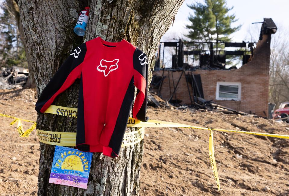 A memorial was erected outside a home in the 4300 block of Skycrest Drive NW in Jackson Township where a fire killed four people early Sunday.