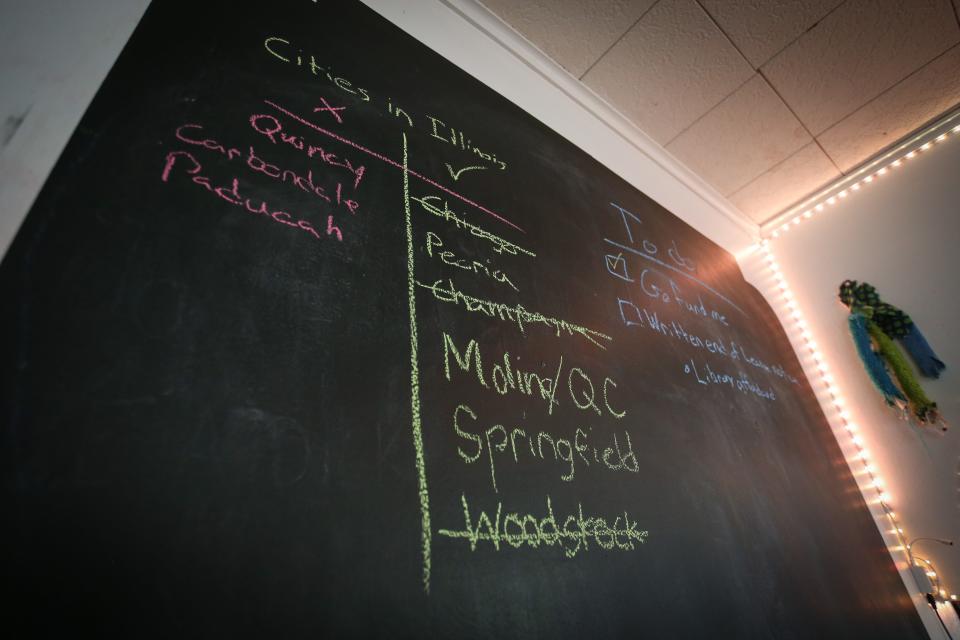 A check-list of Illinois cities on a chalkboard in Andy Rodenbusch, l Nathalie "Hal" Dempsey's home in Springfield on Friday, April 21, 2023. Rodenbusch, Dempsey and their third partner are raising money to move out of Missouri following Attorney General Andrew Bailey's emergency rule on gender-affirming care.