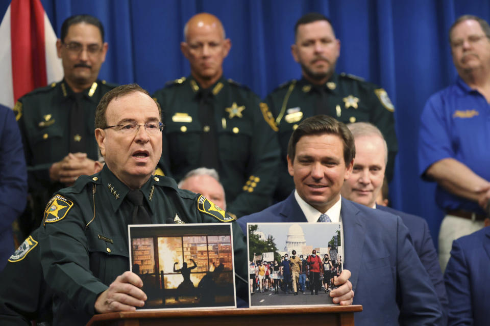 Polk County Sheriff Grady Judd speaks during a press conference with Gov. Ron DeSantis at the Polk County Sheriff's Office in Winter Haven, Fla., on, April 19, 2021. Sheriff Judd, with his folksy Southern drawl, uses social media to target drug dealers, prostitution rings, gangs and human traffickers. (Ricardo Ramirez Buxeda/Orlando Sentinel via AP)